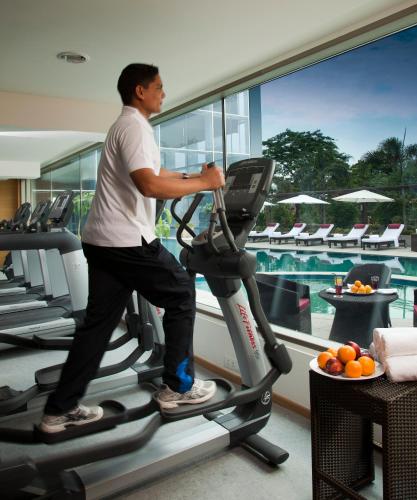 a man running on a treadmill in a gym at Radisson Blu Plaza Hotel Hyderabad Banjara Hills in Hyderabad