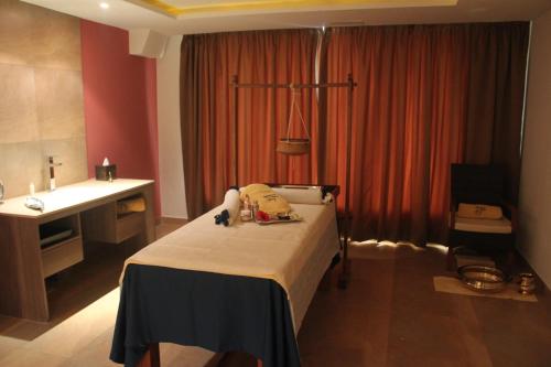 a hotel room with a bed and a sink at Radisson Blu Plaza Hotel Hyderabad Banjara Hills in Hyderabad