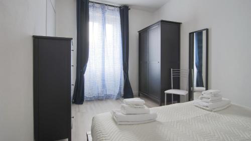 a bedroom with a bed with towels on it at La Terrazza di Casarico in Moltrasio