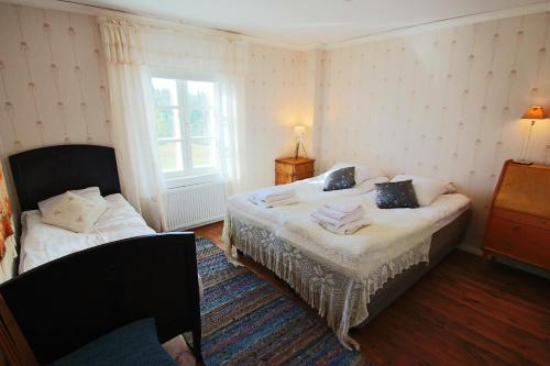 a bedroom with two beds and a window at Elves Village Hotel in Levi