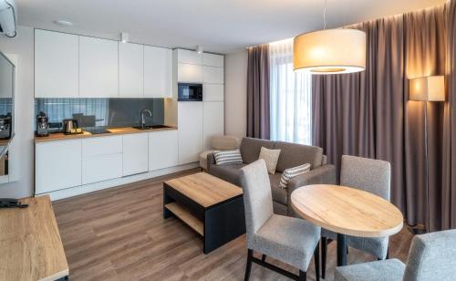 a living room with a couch and a table at Meta Apartments in Szczyrk