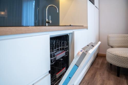 a dishwasher in a kitchen with a sink at Meta Apartments in Szczyrk