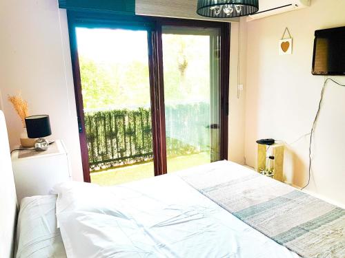 a bedroom with a bed and a large window at Paseo de La Victoria in Córdoba