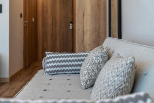 a blue couch with three pillows on it at Meta Apartments in Szczyrk
