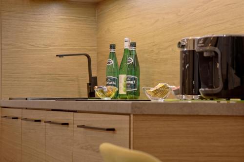 two bottles of beer sitting on top of a counter at Bentis Luxury Apartments in Kraków
