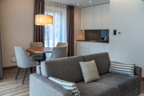 a living room with a couch and a table at Meta Apartments in Szczyrk