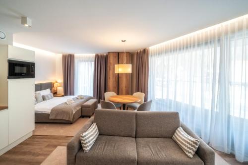 a hotel room with a couch and a bed at Meta Apartments in Szczyrk