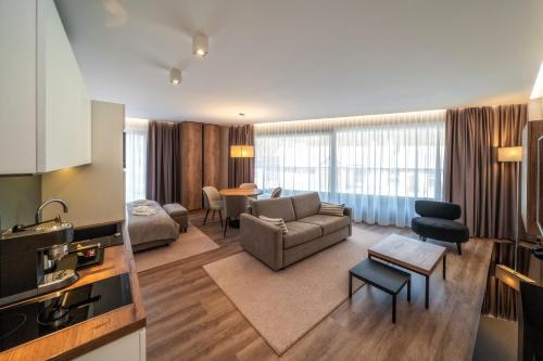 a living room with a couch and a table at Meta Apartments in Szczyrk