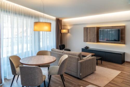 a living room with a couch and a table at Meta Apartments in Szczyrk