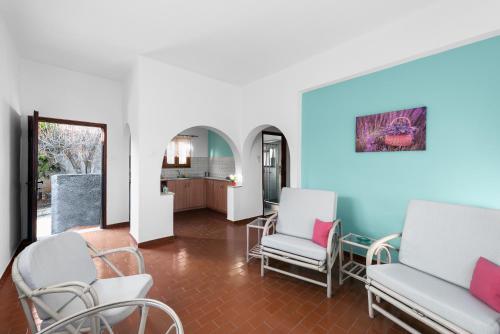 a living room with two chairs and a table at Cavo Grosso Bungalows in Mavrovouni