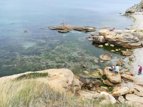 a group of people swimming in a body of water at Hotel Diva in Ravda