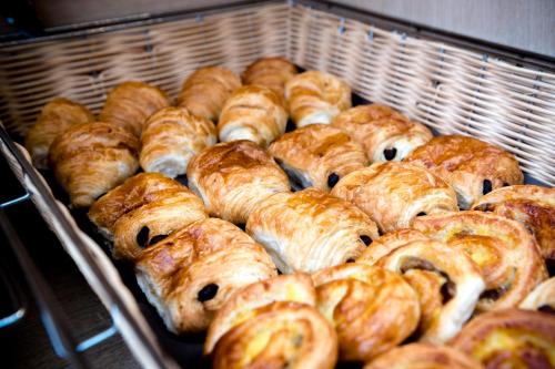 a bunch of croissants and other pastries in an oven at Hotel Albert Plage in Knokke-Heist
