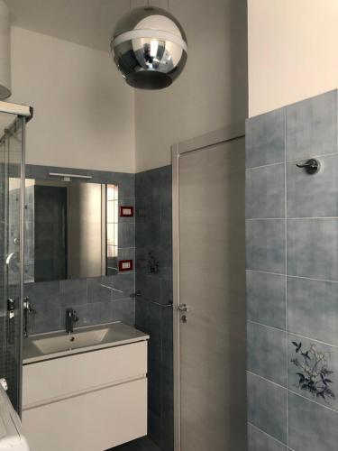a bathroom with a shower and a sink and a mirror at Holiday house in Lungomare Tysandros Giardini Naxos in Giardini Naxos