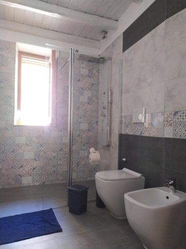 a bathroom with a tub and a toilet and a sink at Siracusa Ortigia by Duomo in Siracusa