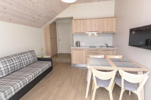 a living room with a couch and a table at Vila Paula in Palanga