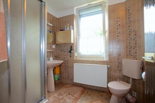 a bathroom with a toilet and a sink and a shower at Private Rooms in Hannover