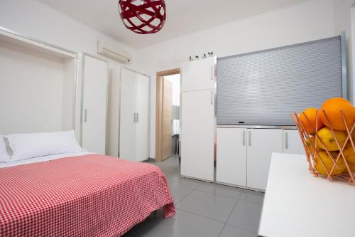 a white bedroom with a bed and a television at Selenite in Capo dʼOrlando