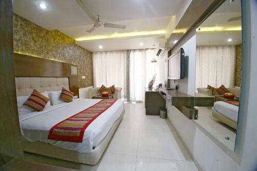 a hotel room with a bed and a television at Hotel Diamond Plaza in Chandīgarh