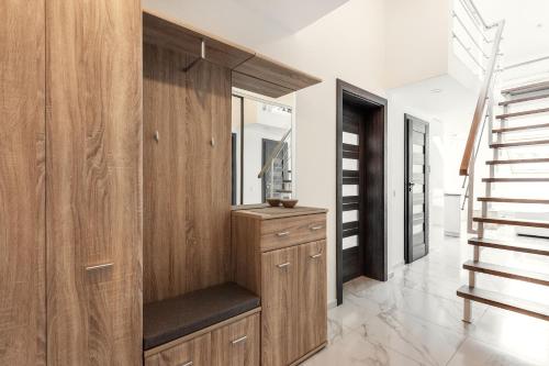 a dressing room with a mirror and a staircase at Luxurious Kaunas Basilica Apartment in Old Town by Urban Rent in Kaunas