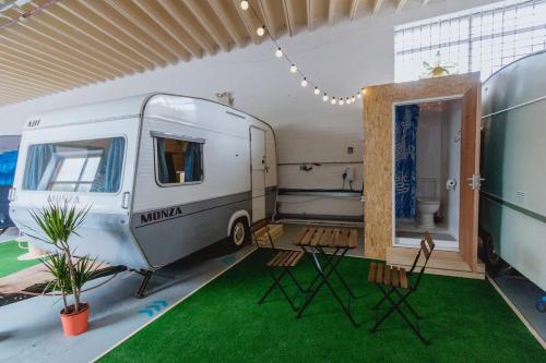 a living room with an rv and a green rug at Towed Town Camping and Event Space in Bristol