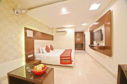 a hotel room with a bed and a television at Hotel Diamond Plaza in Chandīgarh