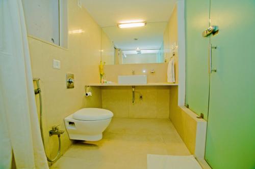a small bathroom with a toilet and a sink at Hotel Clarks Collection Bhavnagar in Bhavnagar