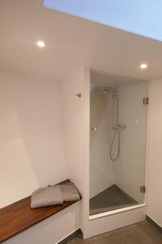 a bathroom with a shower with a glass door at Boathotel Rotterdam Wilhelmina in Rotterdam