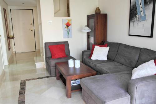 a living room with a couch and two chairs and a table at Townhouse overlooking the pool in San Javier