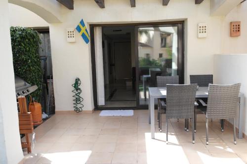 a dining room with a table and chairs at Townhouse overlooking the pool in San Javier