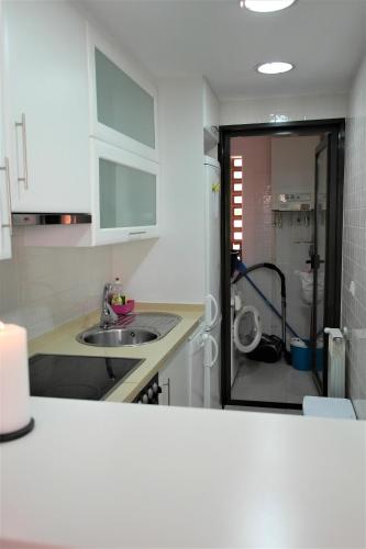 a kitchen with a sink and a counter top at Townhouse overlooking the pool in San Javier