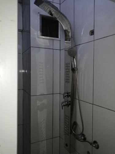 a shower with a shower head in a bathroom at Oludeniz Hostel in Fethiye