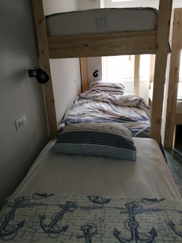 a bunk bed in a small room with a bed underneath at Oludeniz Hostel in Fethiye