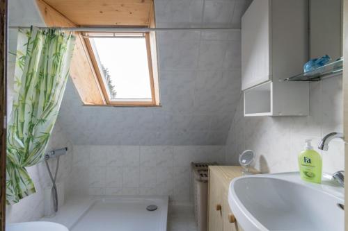 a bathroom with a tub and a sink and a toilet at Private Rooms in Gestorf