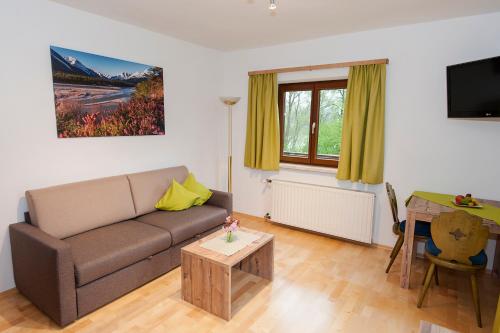 ein Wohnzimmer mit einem Sofa und einem Tisch in der Unterkunft Pension Leuprecht in Reutte