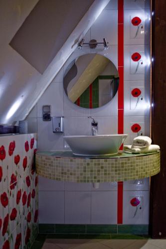 a bathroom with a sink and a mirror at Leśny Dworek Zakopane in Zakopane
