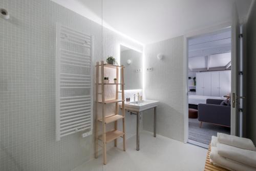 a small bathroom with a sink and a mirror at Malasaña Boutique in Madrid