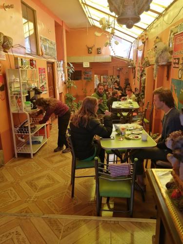 a group of people sitting at tables in a restaurant at Hostal Puerto Alegre in Copacabana