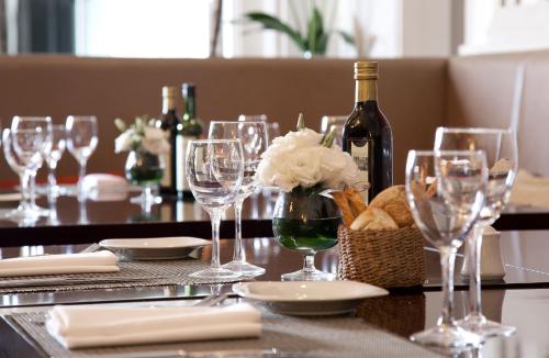 a table with glasses and a bottle of wine at Savoy Hotel in Buenos Aires