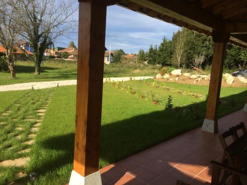 a view of a yard from a porch at La Llastra de Garaña in Llanes
