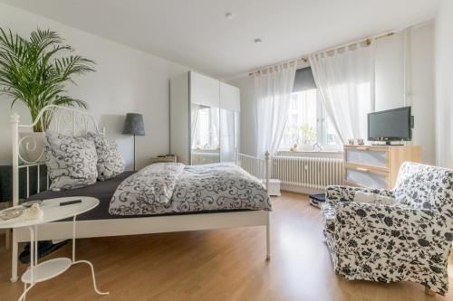 ein Schlafzimmer mit einem Bett und einem Stuhl in der Unterkunft Private Apartment in Hannover