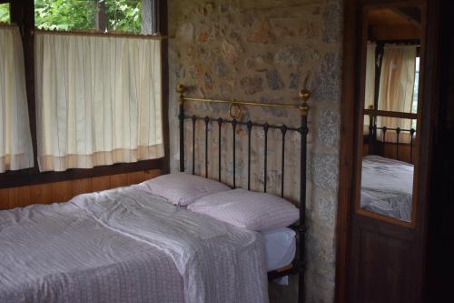 a bedroom with a bed and a window at Small Stone Maisonette 1 in Lílaia