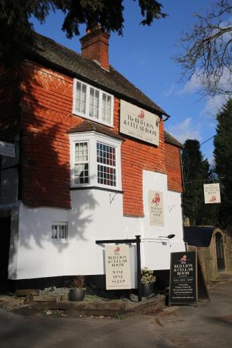a white building with a sign in front of it at The Red Lion & Cellar Room, Betchworth in Betchworth