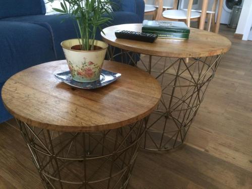 two round tables with a potted plant on them at La Llastra de Garaña in Llanes