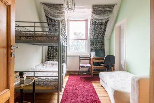 a bedroom with two bunk beds and a desk at Private Rooms in Hannover