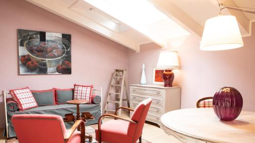 a living room with a table and chairs at Villa Belverde Boutique Hotel in Carrara