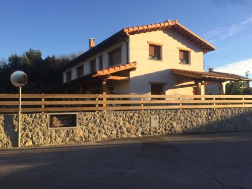 a house with a fence on the side of a street at La Llastra de Garaña in Llanes