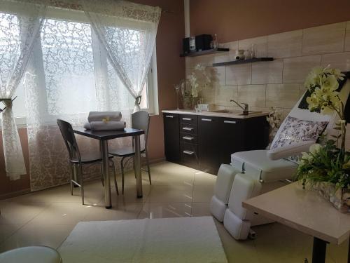 a kitchen with a table and a dining room at Willa Rawia 2 in Rewal