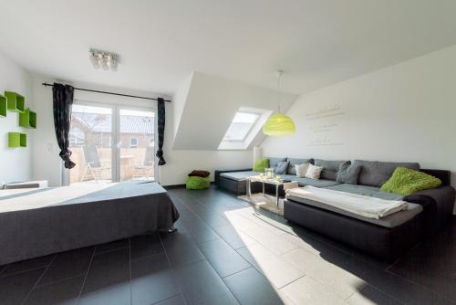 a living room with two beds and a couch at Private Apartment in Hannover