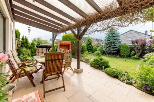 a patio with a table and chairs and a pergola at Private Room in Harsum