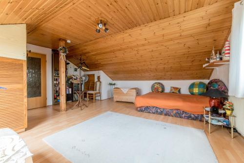 a bedroom with a bed and a wooden ceiling at Private Room in Harsum